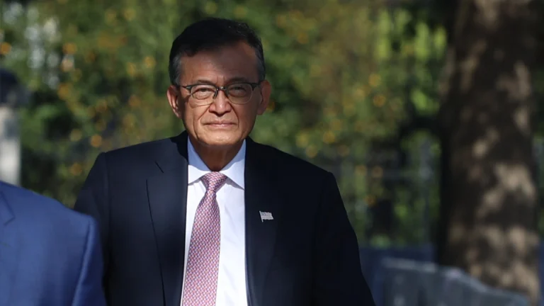 Intel CEO Lip-Bu Tan in a dark suit in the shade.