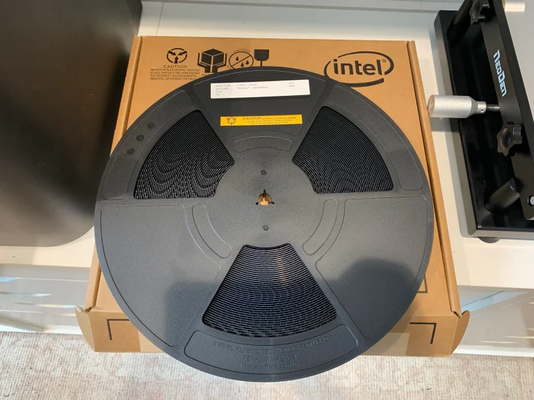 A reel of BZM2 ASICs placed on top of a box marked 