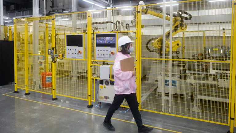 Woman walking past battery testing 